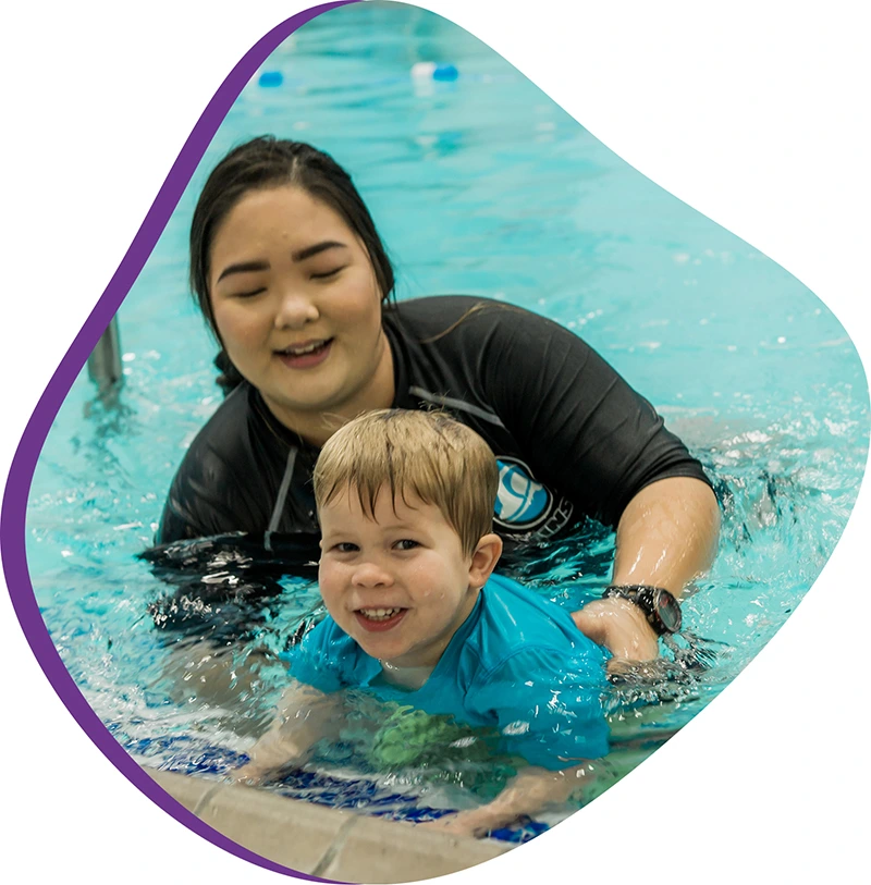 A parent and infant participating in a gentle water acclimation class at FINS Fleet.
