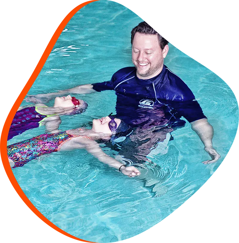 An adult swimmer receiving personalized one-on-one coaching from a FINS instructor in Atascocita.