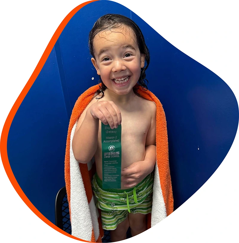 A young swimmer practicing freestyle stroke during a private one-on-one swim lesson at FINS Atascocita.