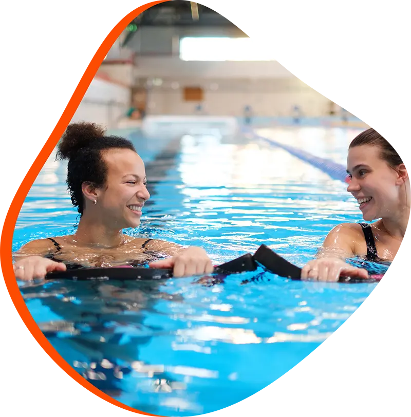 An adult swimmer receiving personalized one-on-one coaching from a FINS instructor in Atascocita.