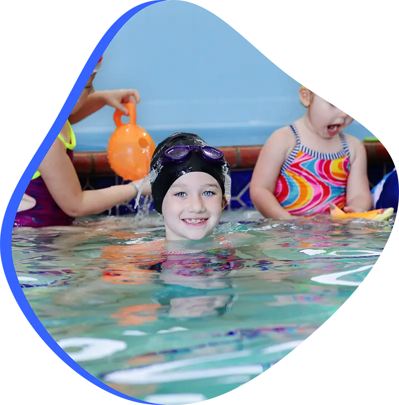A young swimmer practicing freestyle stroke during a private one-on-one swim lesson at FINS Cypress.