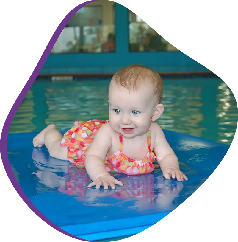 A parent and infant participating in a gentle water acclimation class at FINS Cypress.