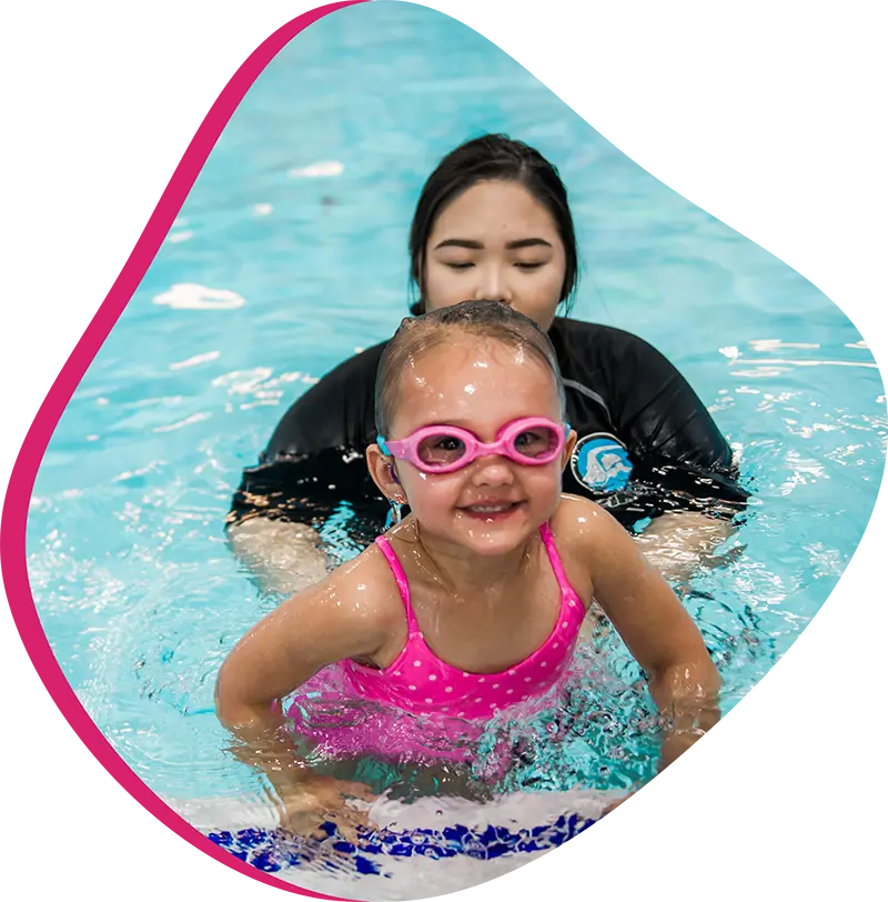 A parent and infant participating in a gentle water acclimation class at FINS Fleet.