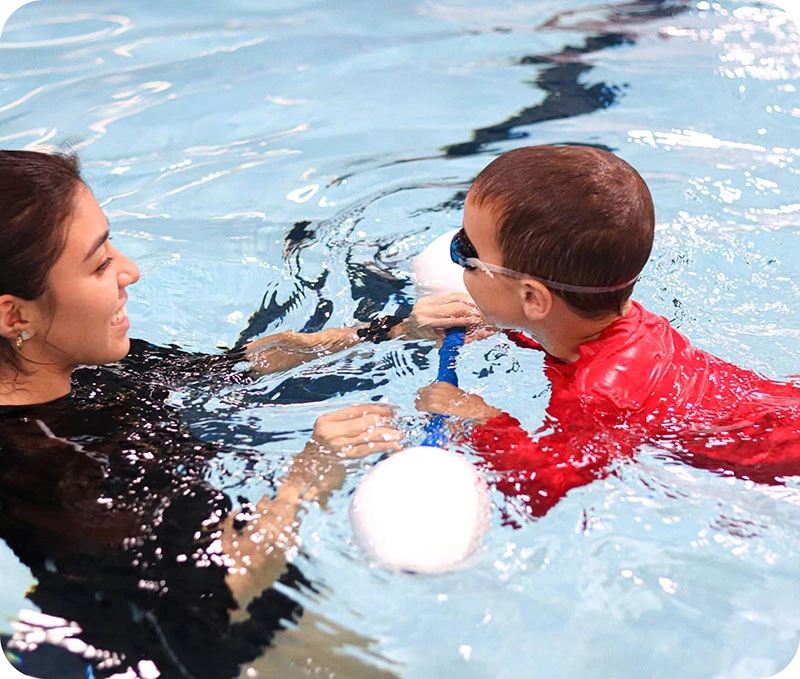 Photos of swimmers and instructors during private swim lessons and events at FINS Grand Parkway.