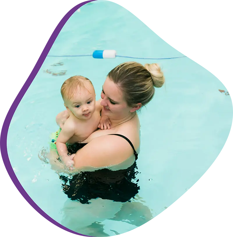 A parent and infant participating in a gentle water acclimation class at FINS Grand Parkway.