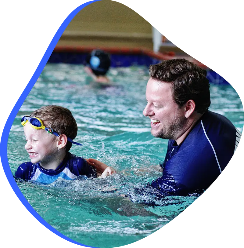  Parent helping child prepare for kids' swim lessons at a swim school