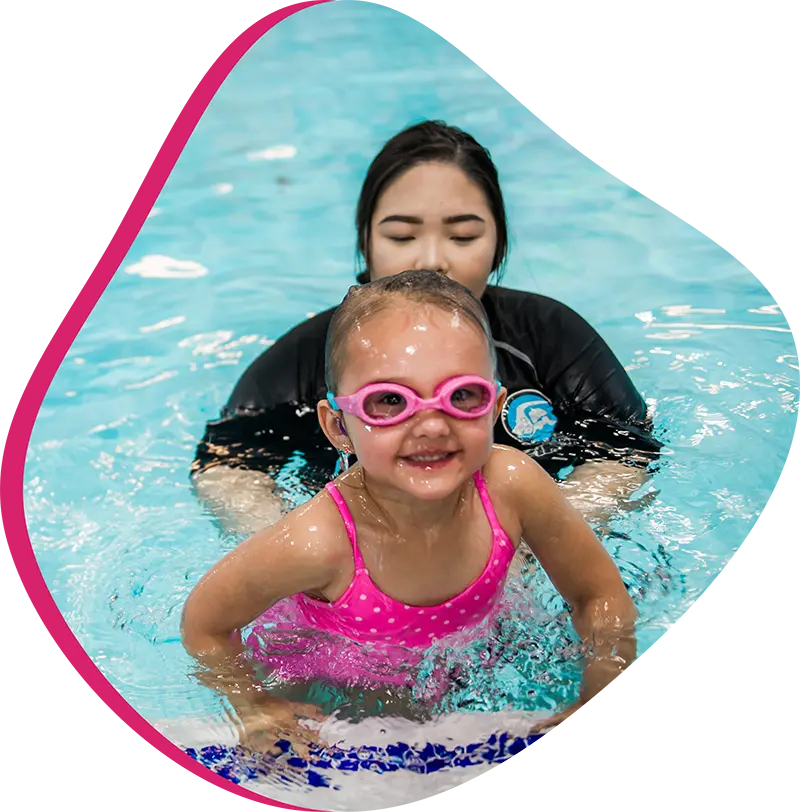 A FINStructor providing 1-on-1 swim coaching to a student in a heated indoor pool in Spring, Texas.