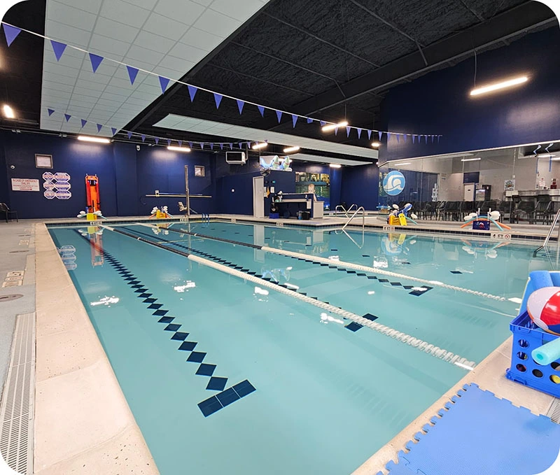 A student successfully practicing a backstroke during a private 1-on-1 swim lesson at the FINS The Woodlands 2978 facility.